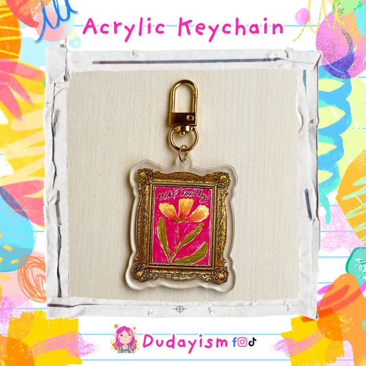 Acrylic keychain with floral design in a gold frame on a colorful background